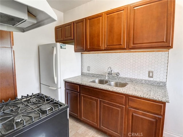 1030 E Ocean Blvd Unit 403, Long Beach, CA 90802 - kitchen with a sink, black range with gas stovetop, exhaust hood, freestanding refrigerator, and light stone countertops