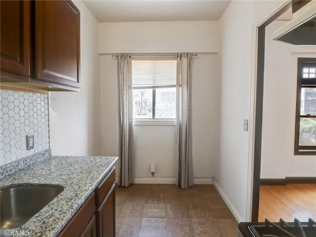1030 E Ocean Blvd Unit 403, Long Beach, CA 90802 - kitchen with backsplash, light stone countertops, and baseboards