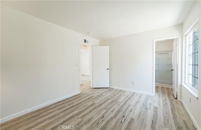 19631 Fagan Way, Cerritos, CA 90703 - unfurnished bedroom featuring light wood-type flooring, multiple windows, a spacious closet, and a closet