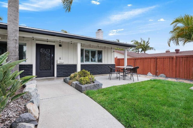 3984 Scott Dr, Carlsbad, CA 92008 - doorway to property with board and batten siding, a chimney, and a porch