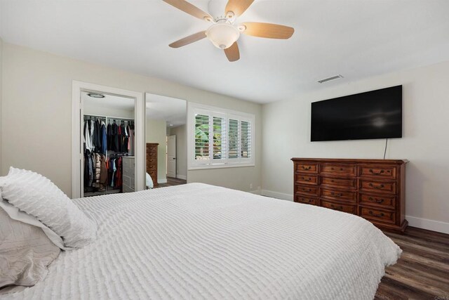 3984 Scott Dr, Carlsbad, CA 92008 - bedroom featuring baseboards, wood finished floors, a ceiling fan, a closet, and a walk in closet