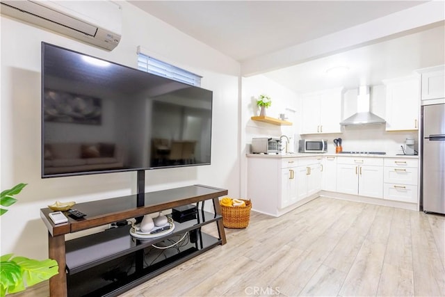 3720 S St Andrews Pl, Los Angeles, CA 90018 - kitchen featuring wall chimney range hood, appliances with stainless steel finishes, an AC wall unit, open shelves, and white cabinetry