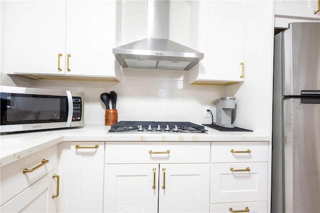 3720 S St Andrews Pl, Los Angeles, CA 90018 - kitchen featuring stainless steel appliances, wall chimney exhaust hood, tasteful backsplash, and white cabinetry