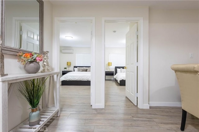 3720 S St Andrews Pl, Los Angeles, CA 90018 - corridor featuring an AC wall unit and light wood finished floors