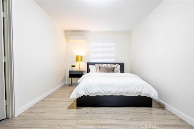 3720 S St Andrews Pl, Los Angeles, CA 90018 - bedroom with a wall mounted AC and wood finished floors