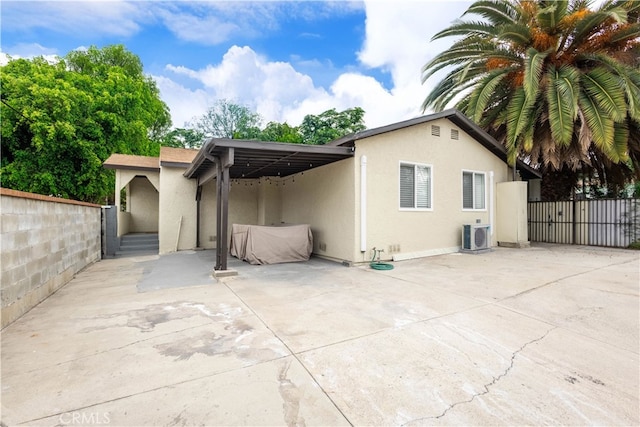3720 S St Andrews Pl, Los Angeles, CA 90018 - back of property featuring stucco siding, a patio area, and a carport
