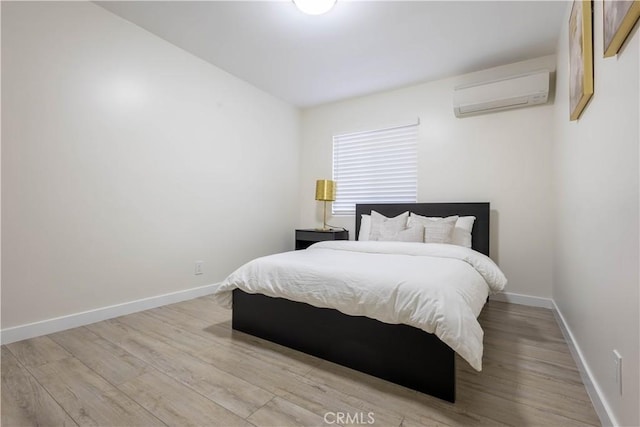 3720 S St Andrews Pl, Los Angeles, CA 90018 - bedroom with a wall mounted air conditioner and light wood-style floors