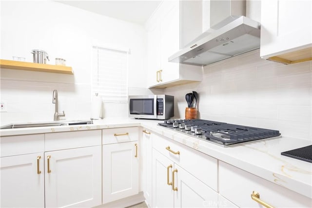 3720 S St Andrews Pl, Los Angeles, CA 90018 - kitchen featuring stainless steel appliances, wall chimney range hood, backsplash, and white cabinets