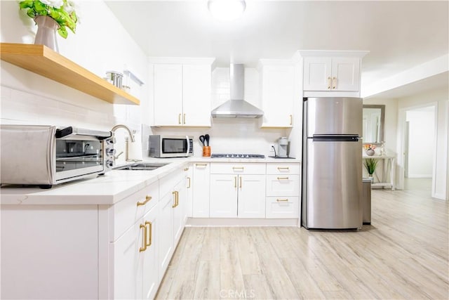 3720 S St Andrews Pl, Los Angeles, CA 90018 - kitchen with appliances with stainless steel finishes, wall chimney exhaust hood, open shelves, and decorative backsplash