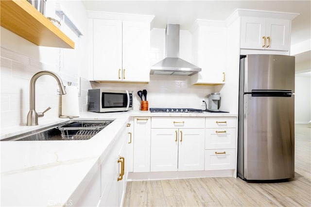 3720 S St Andrews Pl, Los Angeles, CA 90018 - kitchen with appliances with stainless steel finishes, wall chimney range hood, tasteful backsplash, white cabinetry, and light stone counters
