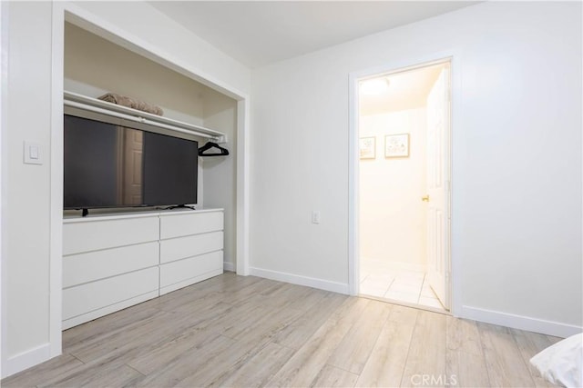 3720 S St Andrews Pl, Los Angeles, CA 90018 - unfurnished bedroom featuring wood finished floors and baseboards