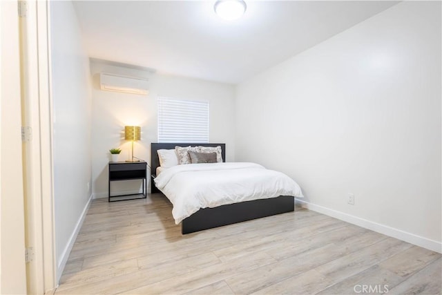 3720 S St Andrews Pl, Los Angeles, CA 90018 - bedroom featuring an AC wall unit and wood finished floors