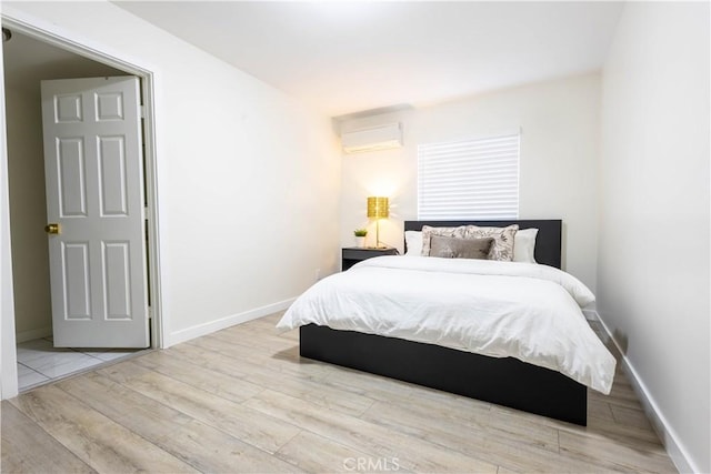 3720 S St Andrews Pl, Los Angeles, CA 90018 - bedroom featuring an AC wall unit and wood finished floors