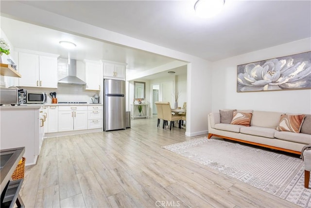 3720 S St Andrews Pl, Los Angeles, CA 90018 - living area with light wood finished floors and baseboards