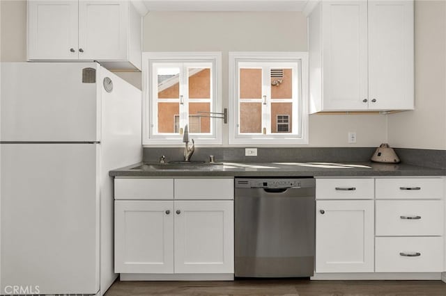 3648 4th Ave, Los Angeles, CA 90018 - kitchen with dishwasher, freestanding refrigerator, white cabinetry, dark countertops, and dark wood-style floors