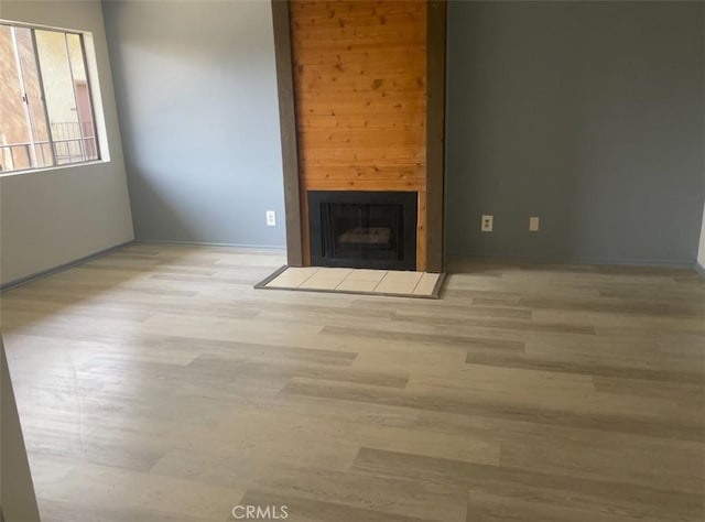 8505 Columbus Ave Unit 316, North Hills, CA 91343 - unfurnished living room with a fireplace, wood finished floors, and baseboards