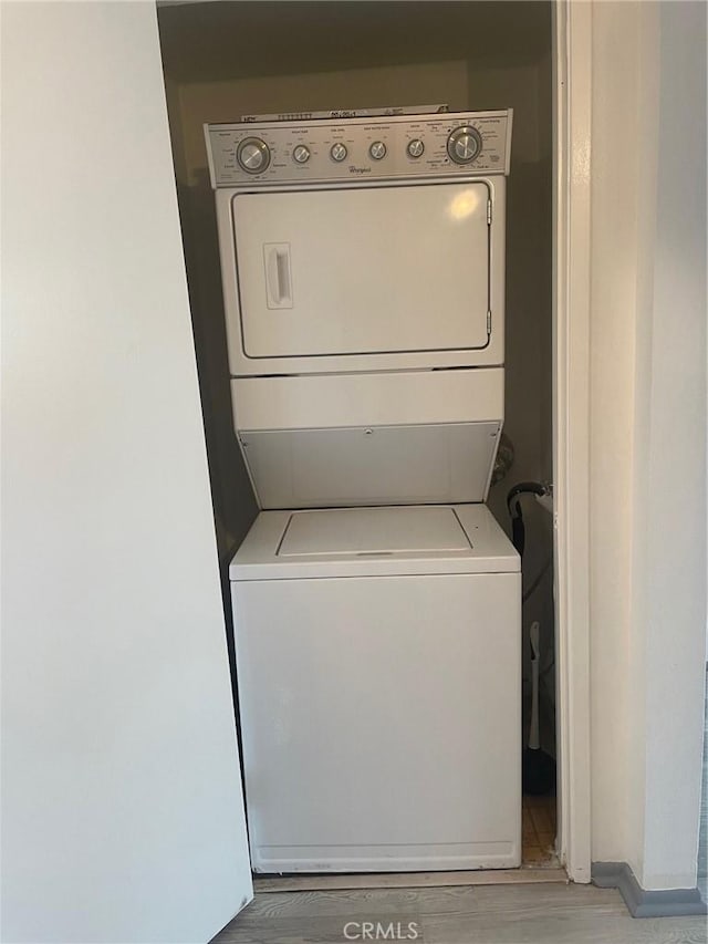 8505 Columbus Ave Unit 316, North Hills, CA 91343 - laundry room with stacked washer and clothes dryer and light wood finished floors