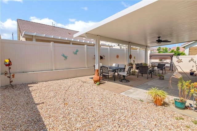 730 Zaphiro Ct, San Jacinto, CA 92583 - fenced backyard with a patio area, ceiling fan, and outdoor dining space
