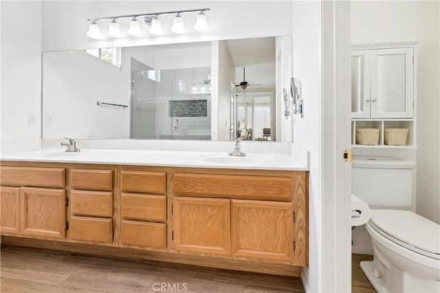 730 Zaphiro Ct, San Jacinto, CA 92583 - bathroom featuring a shower stall, double vanity, toilet, ceiling fan, and wood finished floors