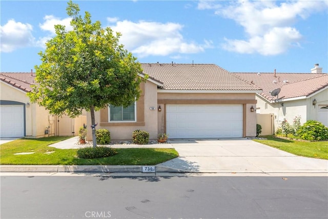 730 Zaphiro Ct, San Jacinto, CA 92583 - view of front of house with a tile roof, concrete driveway, an attached garage, and stucco siding