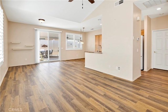 730 Zaphiro Ct, San Jacinto, CA 92583 - unfurnished living room featuring a ceiling fan, wood finished floors, vaulted ceiling, a sink, and baseboards