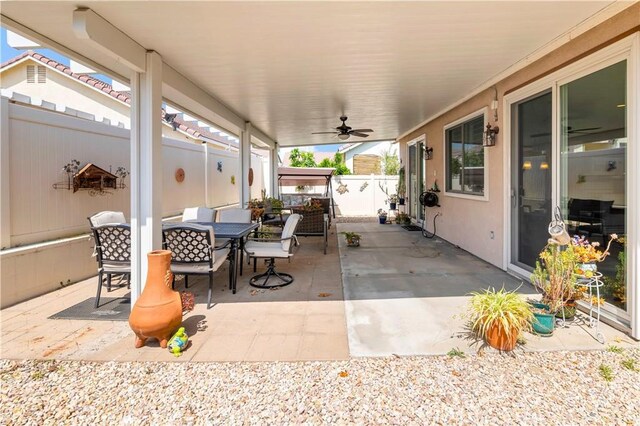 730 Zaphiro Ct, San Jacinto, CA 92583 - fenced backyard with outdoor dining area, a patio area, and a ceiling fan
