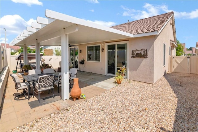 730 Zaphiro Ct, San Jacinto, CA 92583 - back of property with a gate, stucco siding, a fenced backyard, and a ceiling fan
