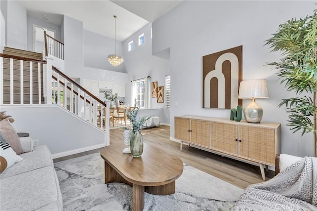 11376 Starlight Dr, Rancho Cucamonga, CA 91701 - living area with healthy amount of natural light, stairs, wood finished floors, a high ceiling, and a chandelier