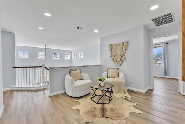 11376 Starlight Dr, Rancho Cucamonga, CA 91701 - living area with wood finished floors, plenty of natural light, recessed lighting, and an upstairs landing
