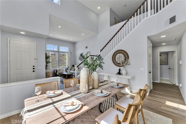 11376 Starlight Dr, Rancho Cucamonga, CA 91701 - dining area with a towering ceiling, wood finished floors, recessed lighting, and stairs