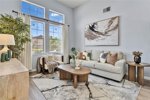 11376 Starlight Dr, Rancho Cucamonga, CA 91701 - living area featuring healthy amount of natural light and wood finished floors