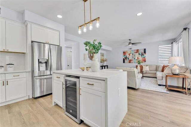 11376 Starlight Dr, Rancho Cucamonga, CA 91701 - kitchen with stainless steel fridge, wine cooler, a ceiling fan, white cabinets, and light wood finished floors