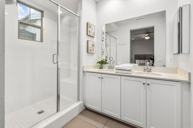 1003 Overton Ct, Tustin, CA 92780 - ensuite bathroom featuring a stall shower, double vanity, a ceiling fan, and tile patterned flooring