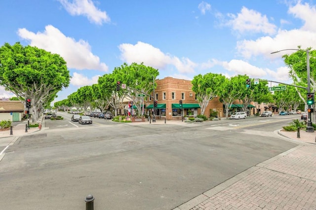 1003 Overton Ct, Tustin, CA 92780 - view of asphalt street with traffic lights, sidewalks, curbs, street lighting, and traffic signs