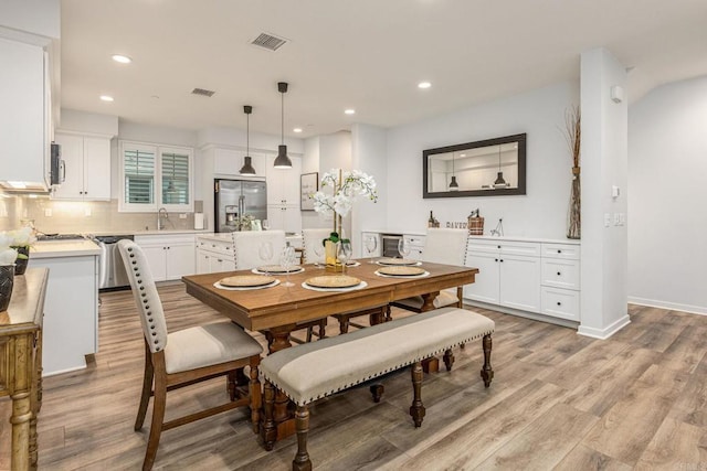 1003 Overton Ct, Tustin, CA 92780 - dining room featuring light wood-style floors, recessed lighting, and baseboards