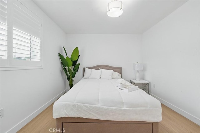1217 W 77th St, Los Angeles, CA 90044 - bedroom with light wood-style flooring and baseboards