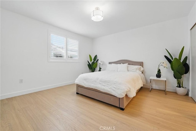 1217 W 77th St, Los Angeles, CA 90044 - bedroom with light wood-type flooring and baseboards