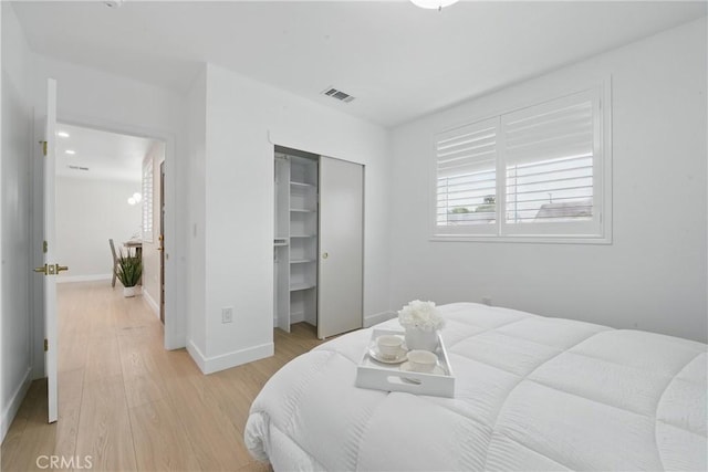 1217 W 77th St, Los Angeles, CA 90044 - bedroom featuring light wood-style flooring, a closet, and baseboards