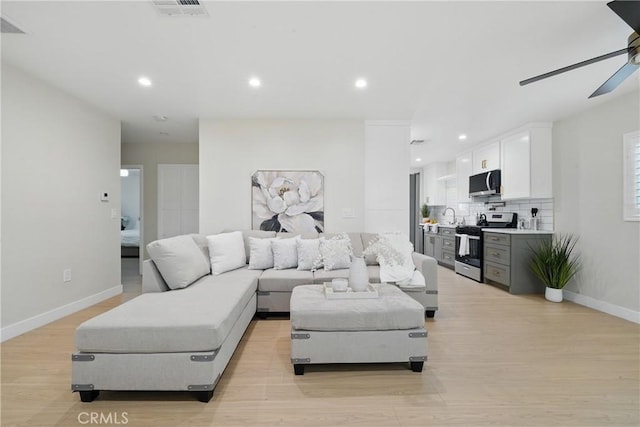 1217 W 77th St, Los Angeles, CA 90044 - living room with ceiling fan, baseboards, light wood finished floors, and recessed lighting