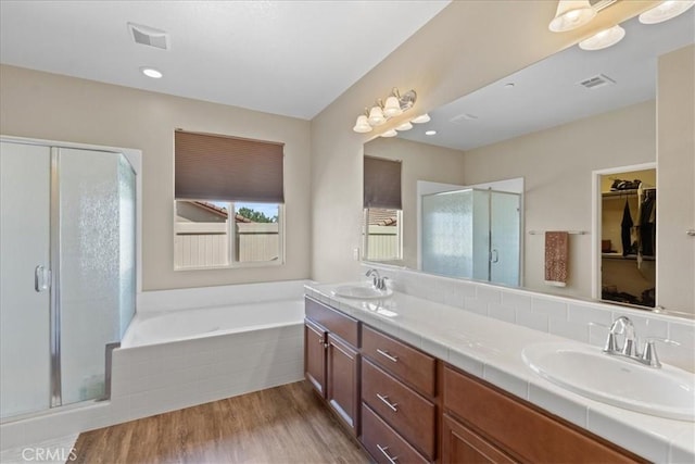 1472 Coyote Ln, Calimesa, CA 92320 - full bath with a shower stall, a garden tub, double vanity, wood finished floors, and a walk in closet