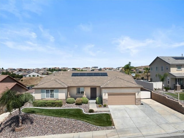 1472 Coyote Ln, Calimesa, CA 92320 - single story home with a garage, a residential view, stucco siding, driveway, and roof mounted solar panels
