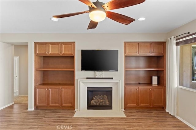 1472 Coyote Ln, Calimesa, CA 92320 - unfurnished living room featuring light wood finished floors, baseboards, a glass covered fireplace, ceiling fan, and recessed lighting