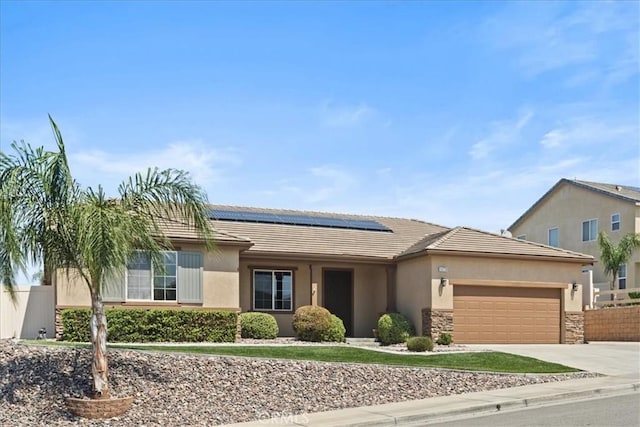 1472 Coyote Ln, Calimesa, CA 92320 - ranch-style house featuring roof mounted solar panels, an attached garage, a tiled roof, stucco siding, and driveway
