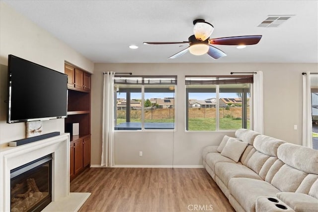 1472 Coyote Ln, Calimesa, CA 92320 - living area with light wood-style floors, ceiling fan, baseboards, plenty of natural light, and recessed lighting