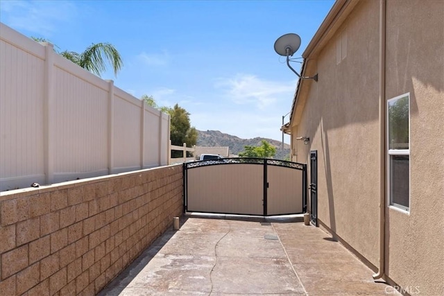 1472 Coyote Ln, Calimesa, CA 92320 - view of patio with a mountain view and a gate