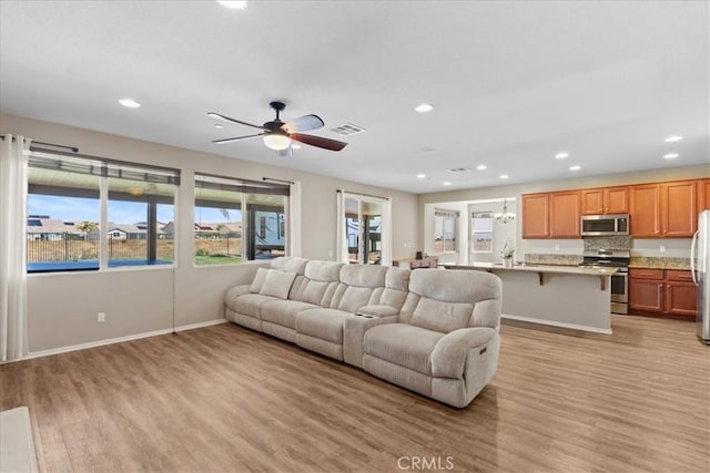 1472 Coyote Ln, Calimesa, CA 92320 - living area featuring light wood-type flooring, healthy amount of natural light, recessed lighting, and ceiling fan