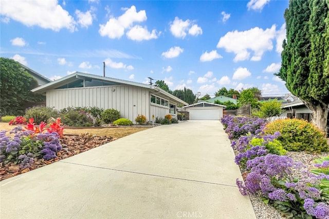 50 Quinta Vista Dr, Thousand Oaks, CA 91362 - view of front of house with board and batten siding, a garage, and an outbuilding