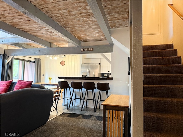 41935 Switzerland Dr Unit 113, Big Bear Lake, CA 92315 - living room featuring beamed ceiling, stairs, and a ceiling fan