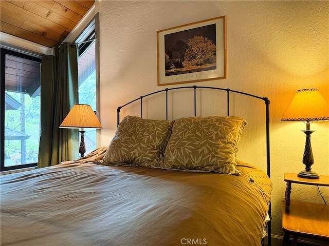 41935 Switzerland Dr Unit 113, Big Bear Lake, CA 92315 - bedroom featuring a textured wall, multiple windows, and lofted ceiling