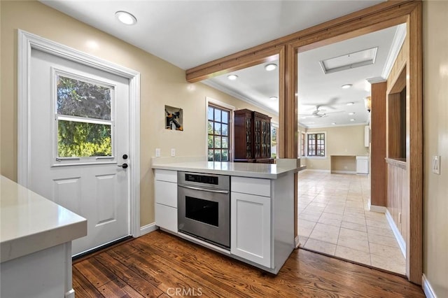 15454 Sutton St, Sherman Oaks, CA 91403 - kitchen featuring oven, a peninsula, baseboards, white cabinets, and recessed lighting